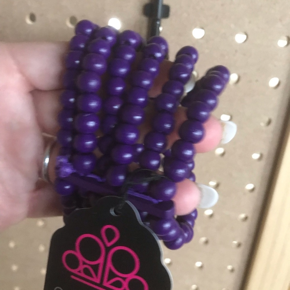 Stretchy wooden purple bead bracelet. Six strands